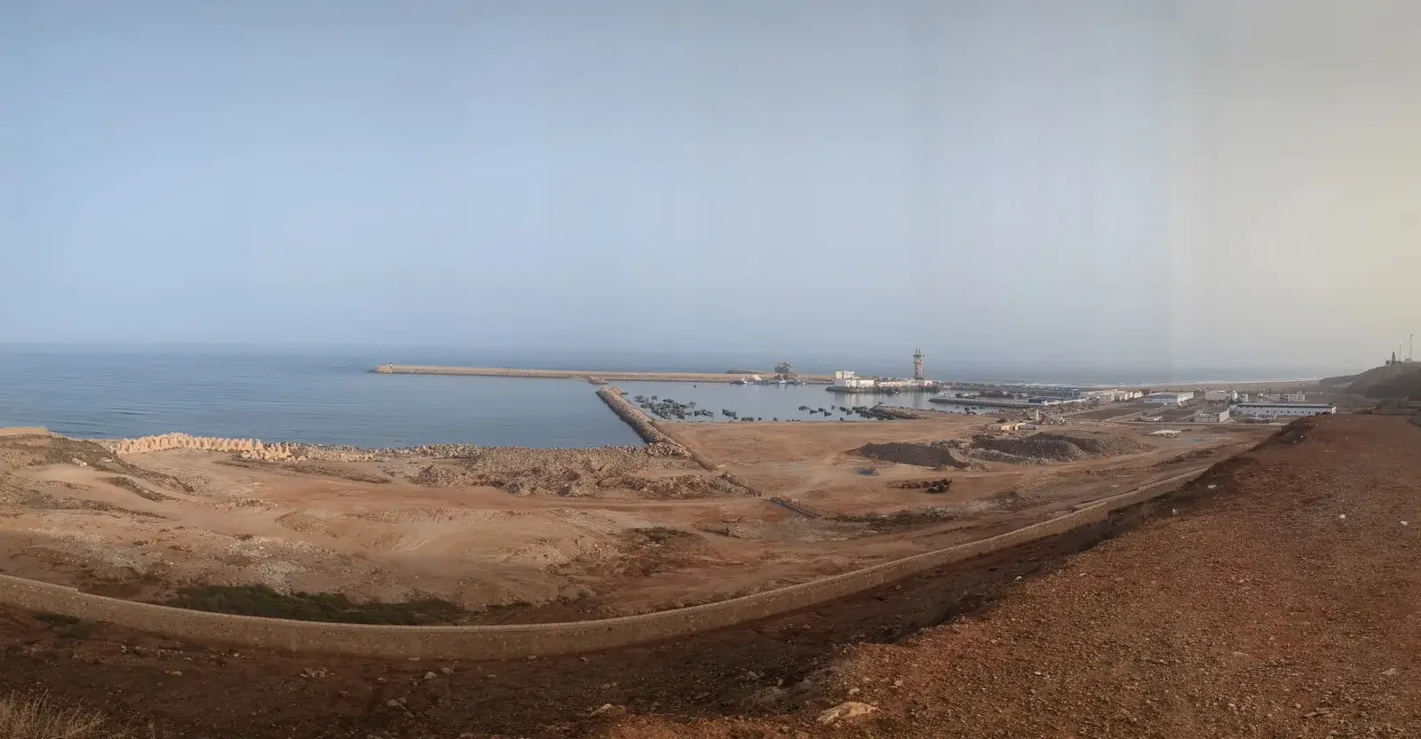 Panoramic view of Sidi Ifni harbour, breakwater and Atlantic coastline